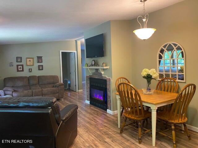 dining area featuring a fireplace and hardwood / wood-style flooring