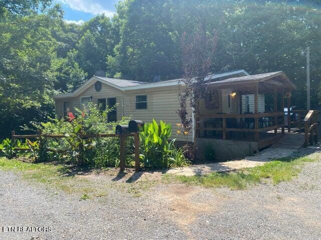 rear view of property featuring a deck