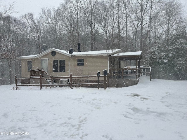 view of snow covered rear of property