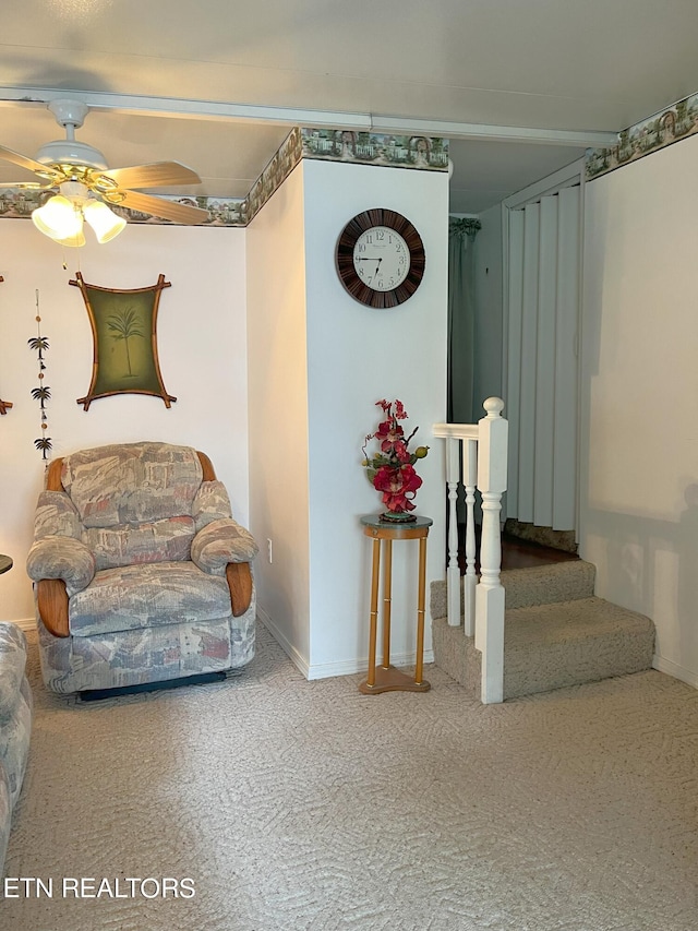 living area with ceiling fan and carpet