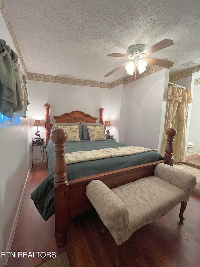 bedroom with a textured ceiling, ceiling fan, and wood-type flooring