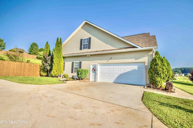 view of front of house featuring a front yard and a garage