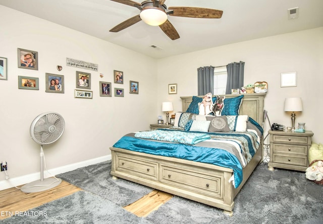 bedroom with ceiling fan and dark hardwood / wood-style flooring