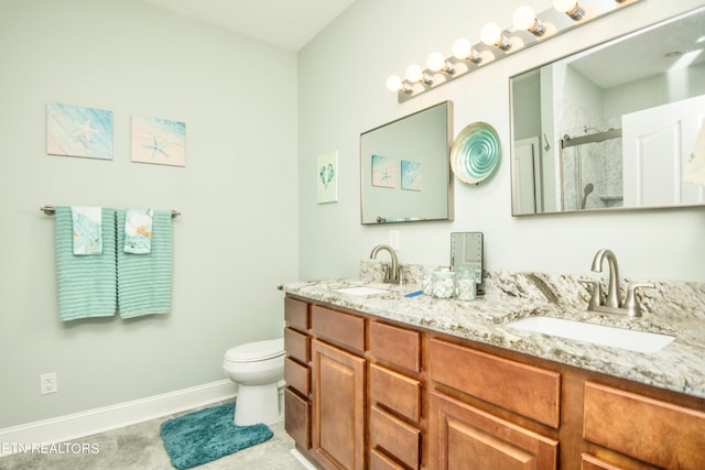 bathroom with toilet, a shower with door, and vanity