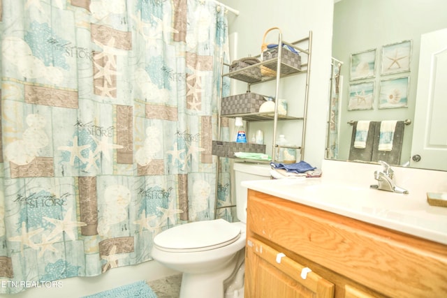 bathroom with toilet, vanity, and a shower with curtain