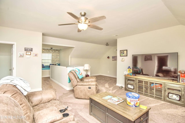 living room featuring ceiling fan, lofted ceiling, and light colored carpet