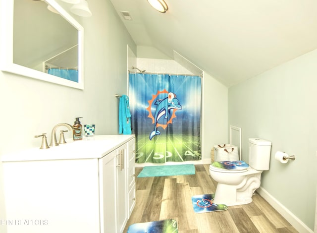 bathroom featuring toilet, lofted ceiling, hardwood / wood-style floors, and vanity