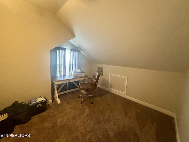 unfurnished office featuring carpet and vaulted ceiling