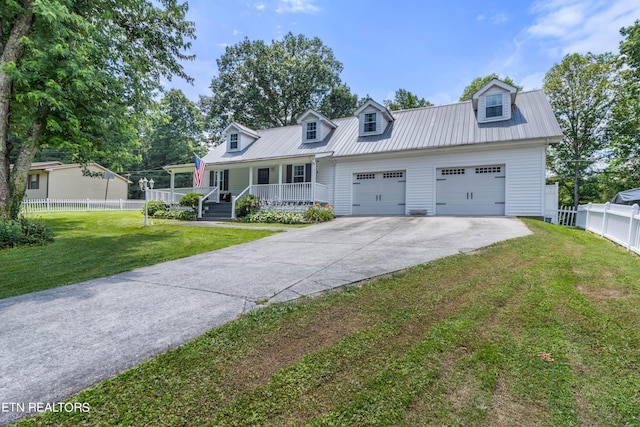 cape cod house with covered porch, a garage, and a front yard