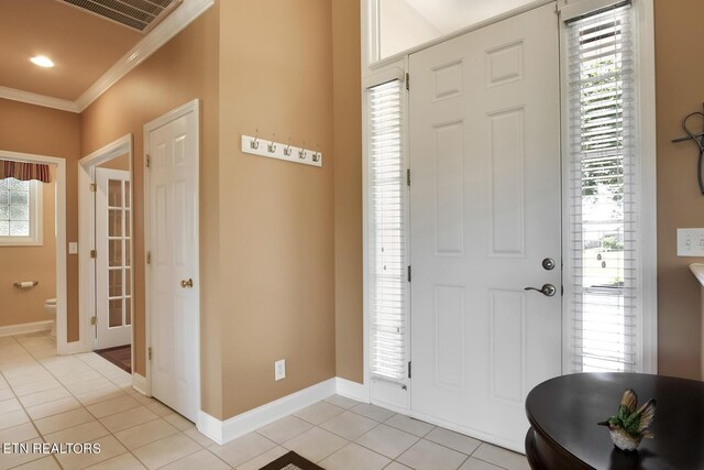 tiled foyer with crown molding