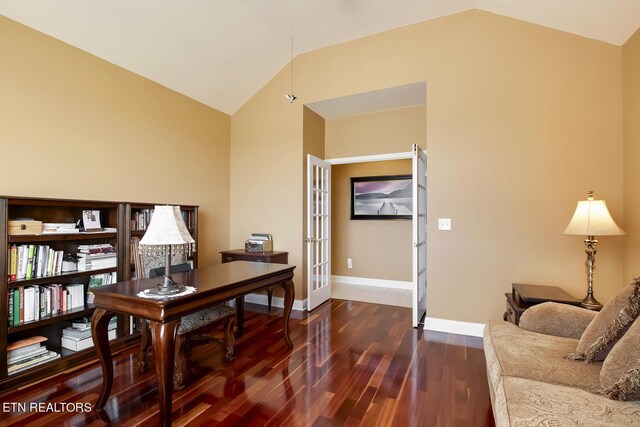 home office with lofted ceiling, dark hardwood / wood-style floors, and french doors