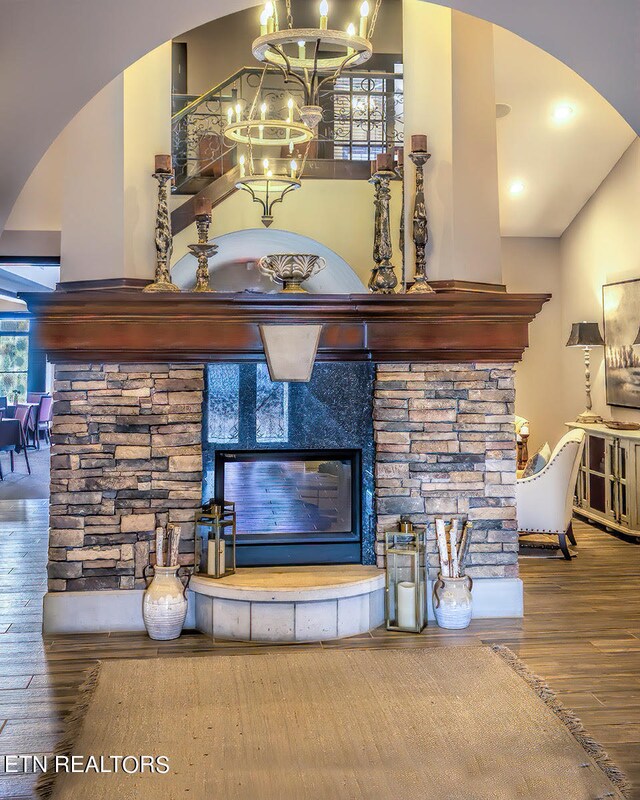 room details with hardwood / wood-style floors and a notable chandelier