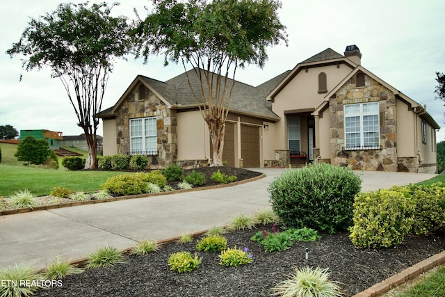 view of front of property with a front lawn and a garage