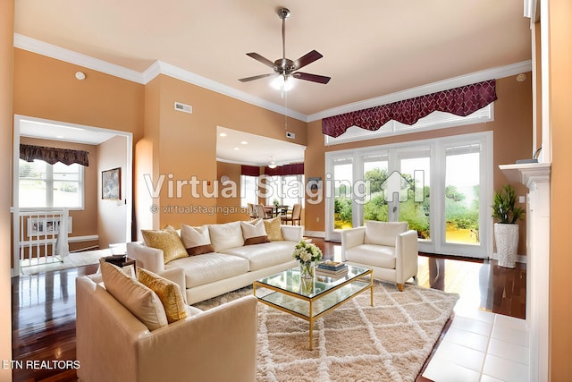 living room with ornamental molding, tile patterned floors, and ceiling fan