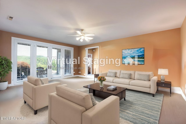 living room featuring light colored carpet and ceiling fan