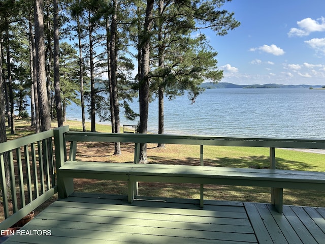 wooden deck featuring a water and mountain view