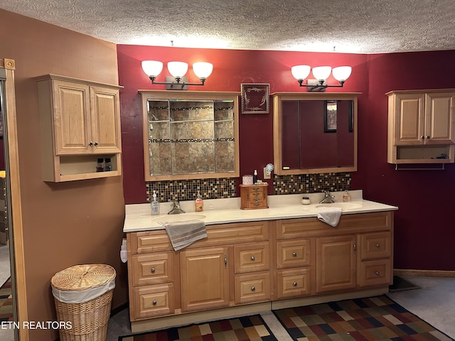 bathroom with tasteful backsplash, vanity, and a textured ceiling