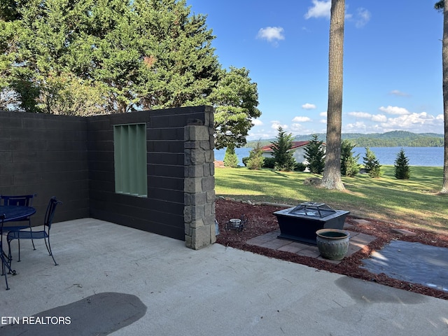 view of patio / terrace with a fire pit and a water and mountain view