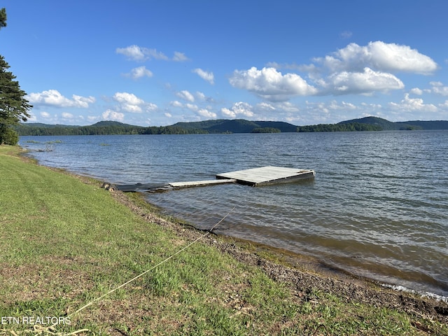 dock area featuring a water and mountain view