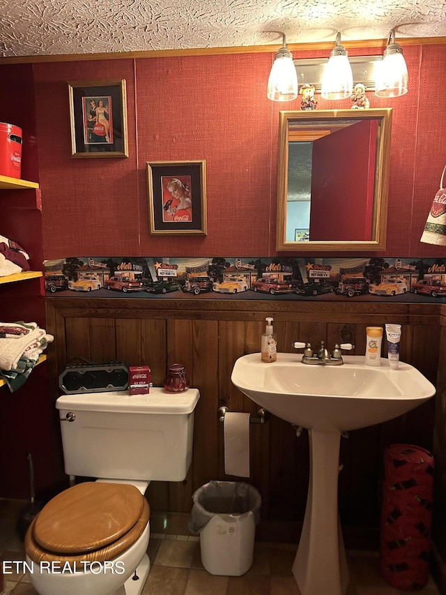 bathroom with tile patterned flooring, toilet, and sink