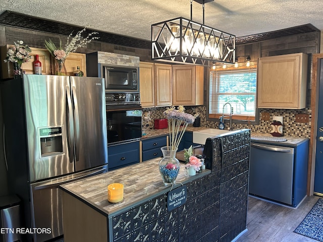 kitchen with a textured ceiling, sink, black appliances, a center island, and dark hardwood / wood-style floors