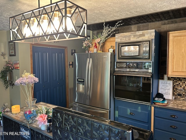 kitchen featuring backsplash, blue cabinetry, and black appliances