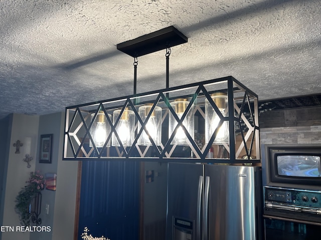 room details featuring black oven and stainless steel fridge