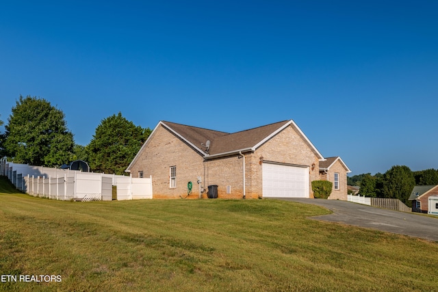 view of front of home with a garage and a front lawn