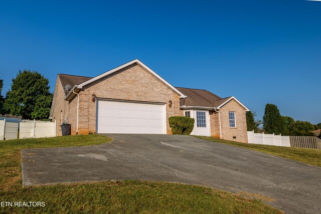 ranch-style home featuring a garage