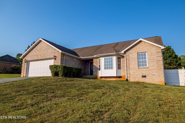 ranch-style home with a front yard and a garage