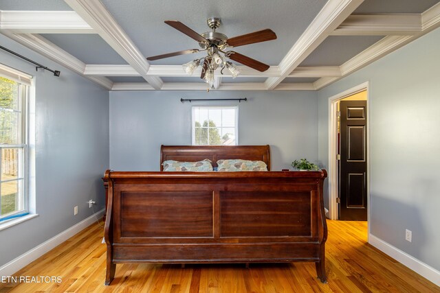 bedroom with light wood-type flooring, coffered ceiling, and ceiling fan