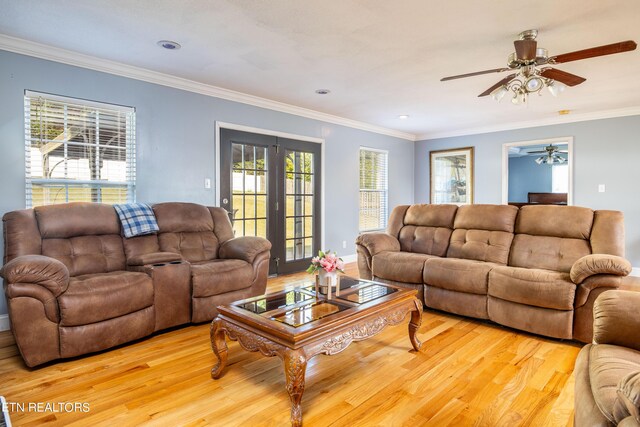 living room featuring french doors, ceiling fan, crown molding, and light hardwood / wood-style flooring