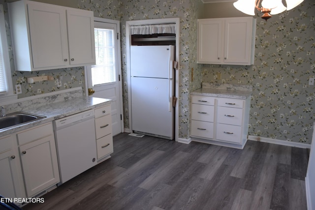 kitchen featuring white cabinetry, sink, white appliances, and dark wood-type flooring