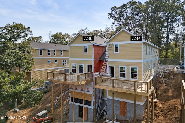 rear view of property featuring a deck