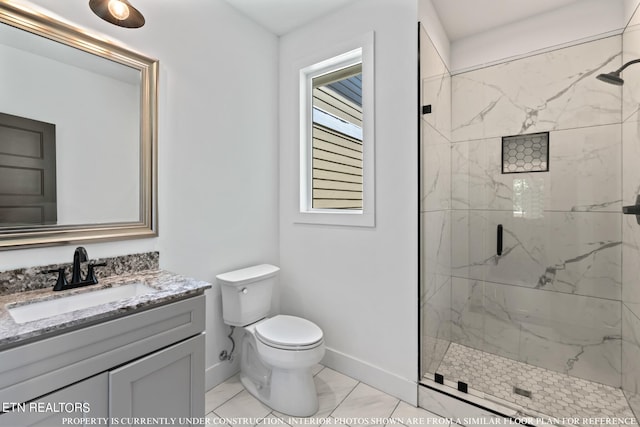 bathroom with vanity, toilet, a tile shower, and tile patterned floors