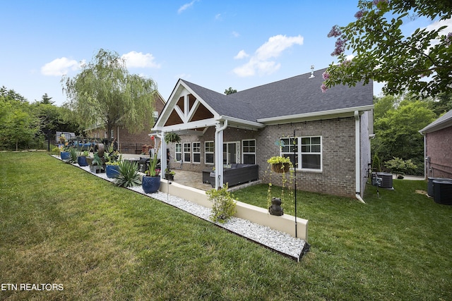 rear view of house featuring a patio area, an outdoor living space, a lawn, and central air condition unit