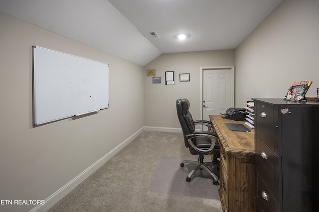 carpeted office with vaulted ceiling