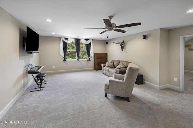 living area featuring ceiling fan and carpet floors