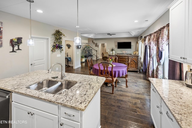 kitchen with sink, white cabinetry, and pendant lighting