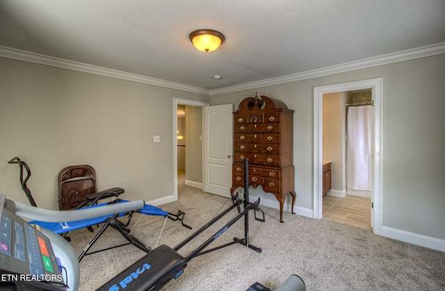 workout room with ornamental molding and light colored carpet