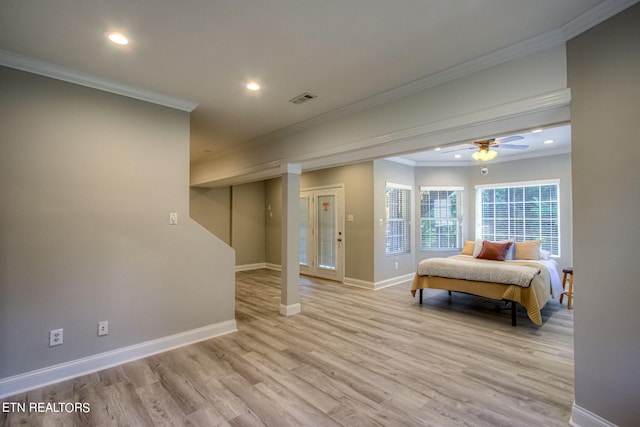 bedroom featuring ornamental molding and light hardwood / wood-style floors