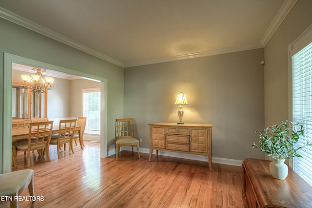 sitting room featuring ornamental molding, a chandelier, and light hardwood / wood-style flooring