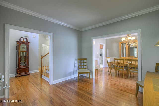 sitting room featuring crown molding, an inviting chandelier, and light wood-type flooring