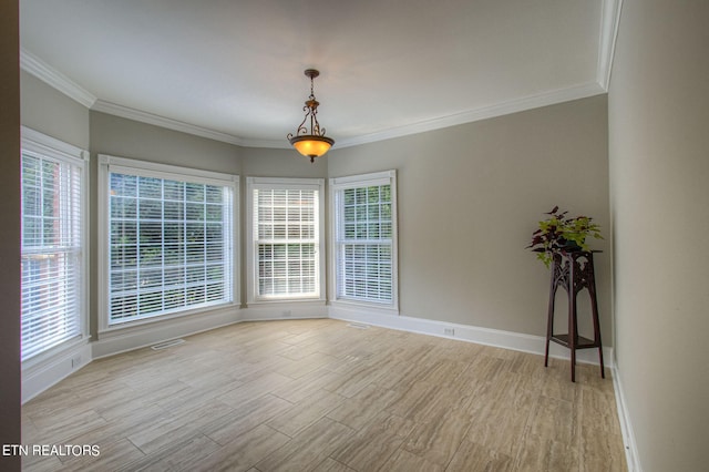 spare room with crown molding and light hardwood / wood-style floors