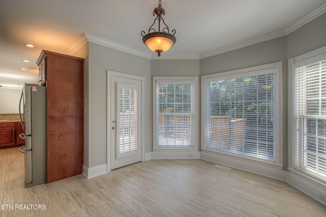 interior space with crown molding and a healthy amount of sunlight