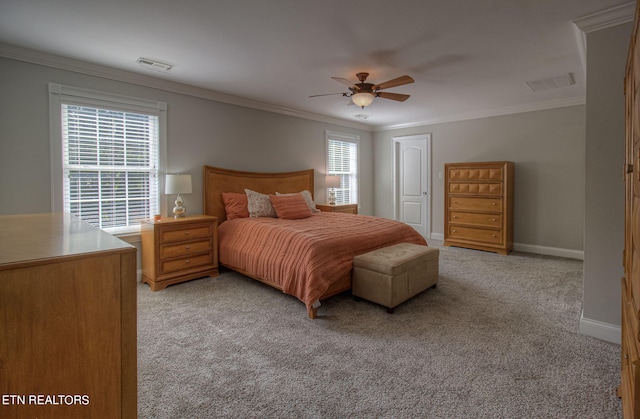 bedroom with crown molding, ceiling fan, a closet, and light carpet