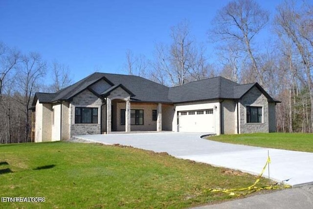 view of front facade with a front yard and a garage