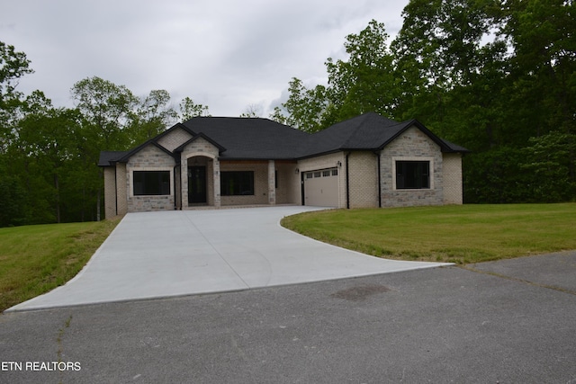 view of front facade with a garage and a front lawn