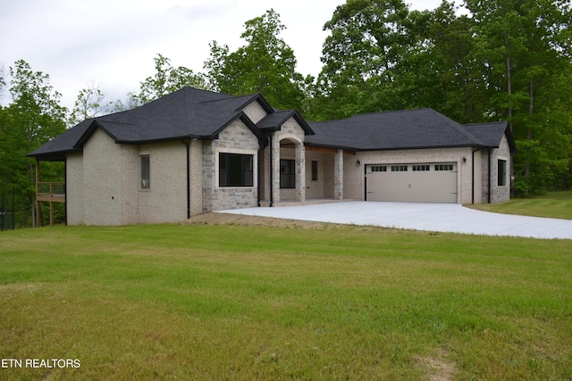 french country home with a front lawn and a garage