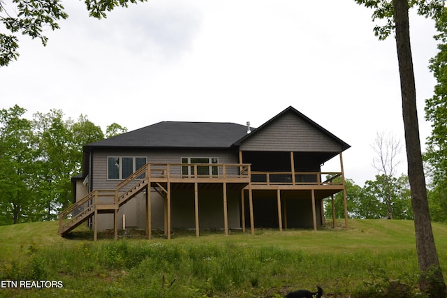 rear view of house featuring a wooden deck